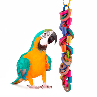 The bird toy with blue and gold macaw standing next to it.