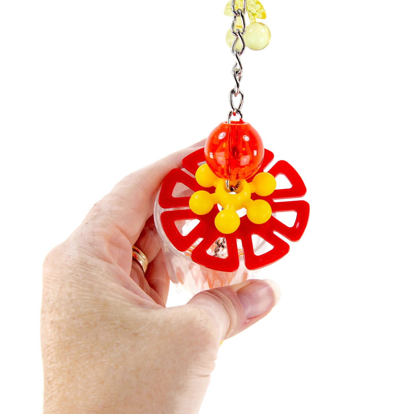 A close up of the top of the foraging bird toy held in a hand for scale.