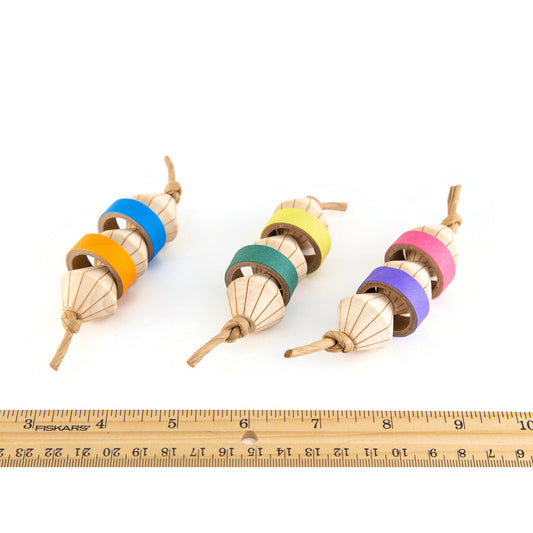 Colorful wooden bird  toys with a ruler for scale. They are 4 inches long by 1 1/2 inches in diameter.