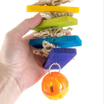 Colorful pet toy with a bell held by a hand on a white background