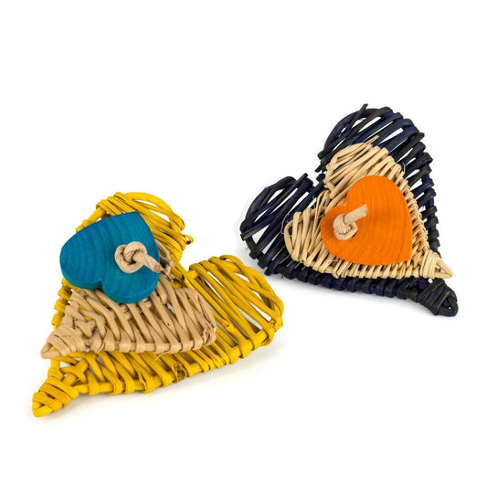 Two heart-shaped rattan toys with colorful wood hearts attached on a white background