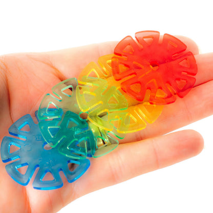 Colorful plastic flower-shaped items held in a hand against a white background